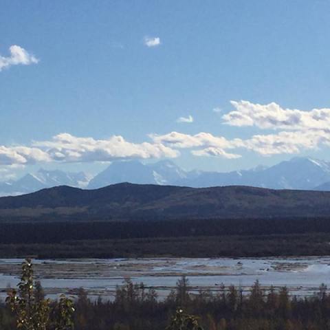 a body of water with a mountain in the background
