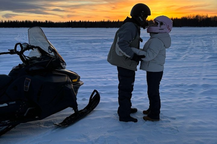 a man standing next to a body of water