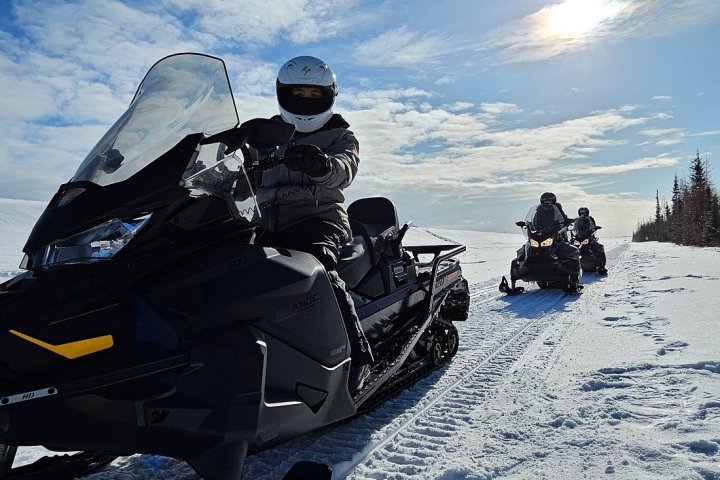 a group of people sitting in the snow