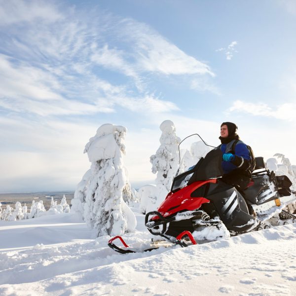 a group of people riding on top of a snow covered slope