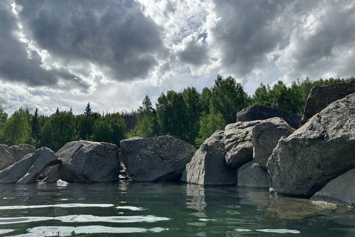 a close up of a large rock next to water