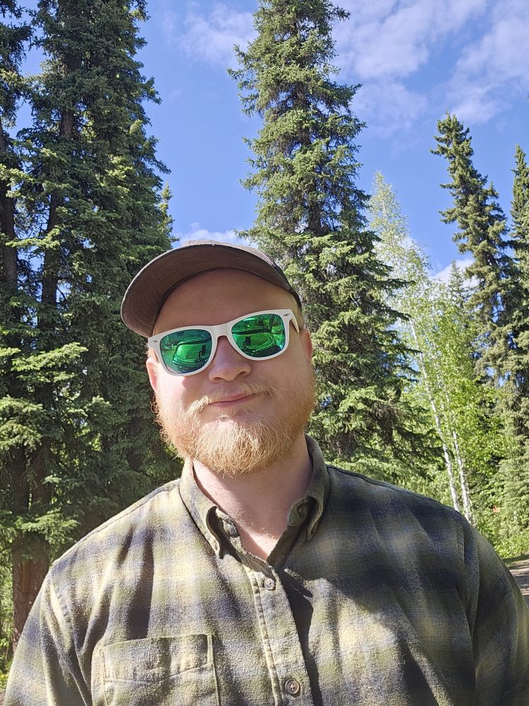 a man wearing a hat and sunglasses